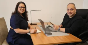 Ada and George Rosales, BOUNCE founders, working together at a desk on workforce marketing strategy.